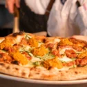 Wood-fired pizza served by a chef at The Exchange restaurant in Lancaster City PA