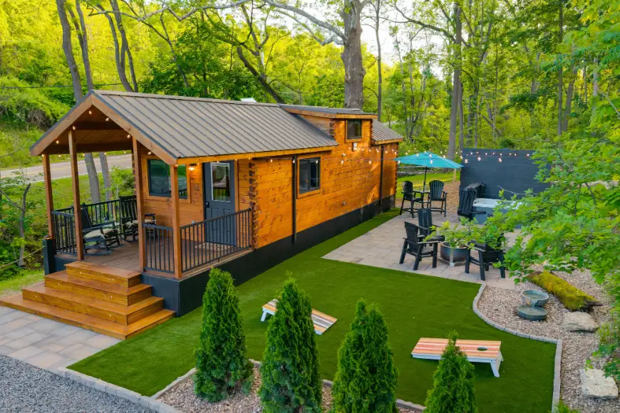 Aerial view of custom backyard cabin with wraparound porch, artificial turf, and pool area in Lancaster PA by Luxscapes Unlimited