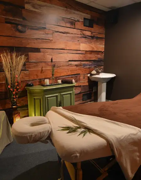 Relaxing massage room with reclaimed wood walls at Body and Sole spa in Lancaster County PA