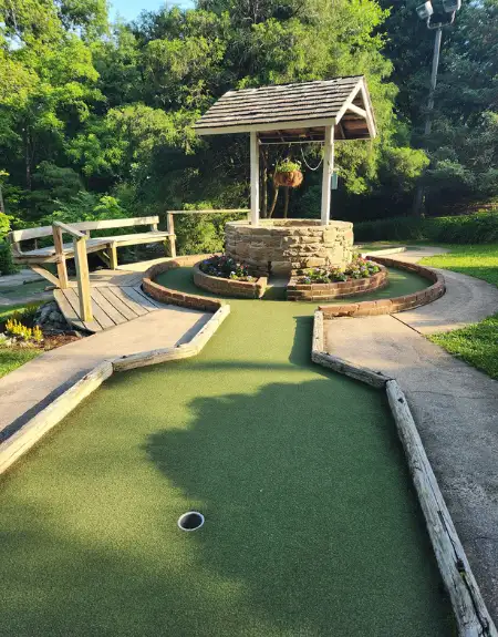 Outdoor mini golf course with wishing well obstacle at Village Greens Mini Golf in Lancaster County PA