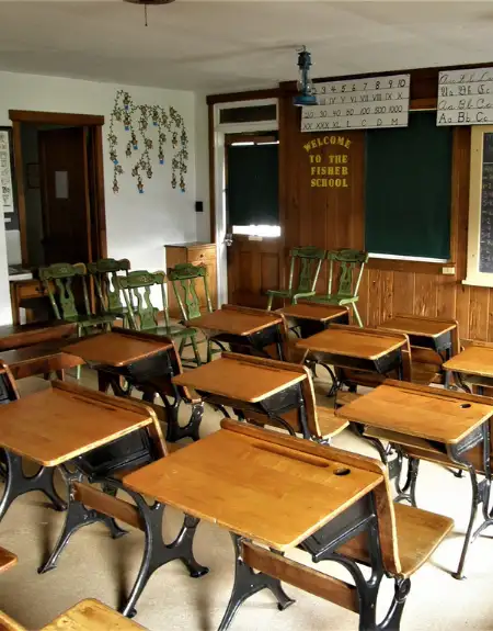 Historic Amish one-room schoolhouse interior with wooden desks at Fisher School museum in Lancaster County PA