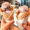 Two waffle cone ice cream scoops held up at Fox Meadows Creamery in Lancaster County PA