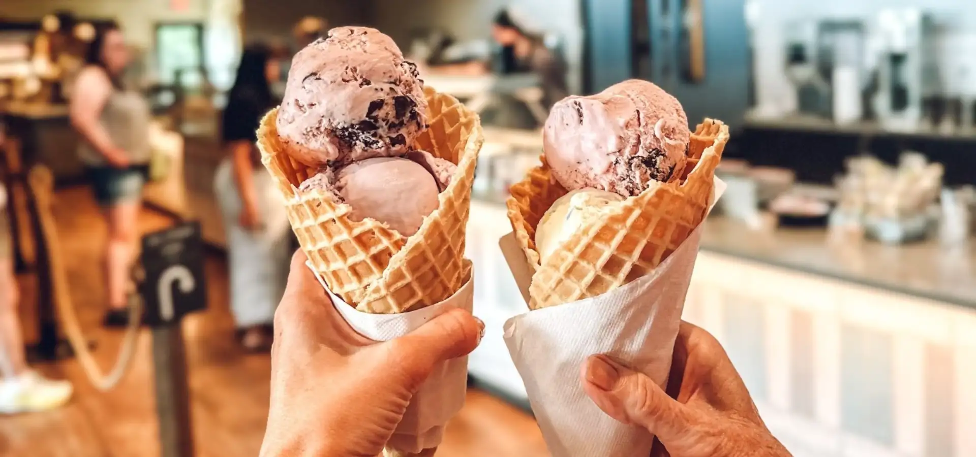 Two waffle cone ice cream scoops held up at Fox Meadows Creamery in Lancaster County PA