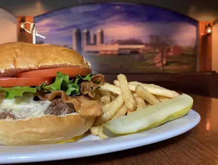 Bacon cheeseburger with fries and pickle served at The Restaurant at Oregon Dairy in Lancaster PA