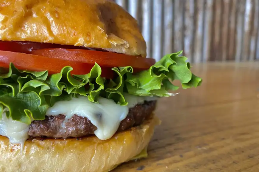 Close-up of a fresh cheeseburger with lettuce and tomato at The Restaurant at Oregon Dairy in Lancaster PA