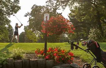 Golfer teeing off on a scenic golf course in Lancaster PA