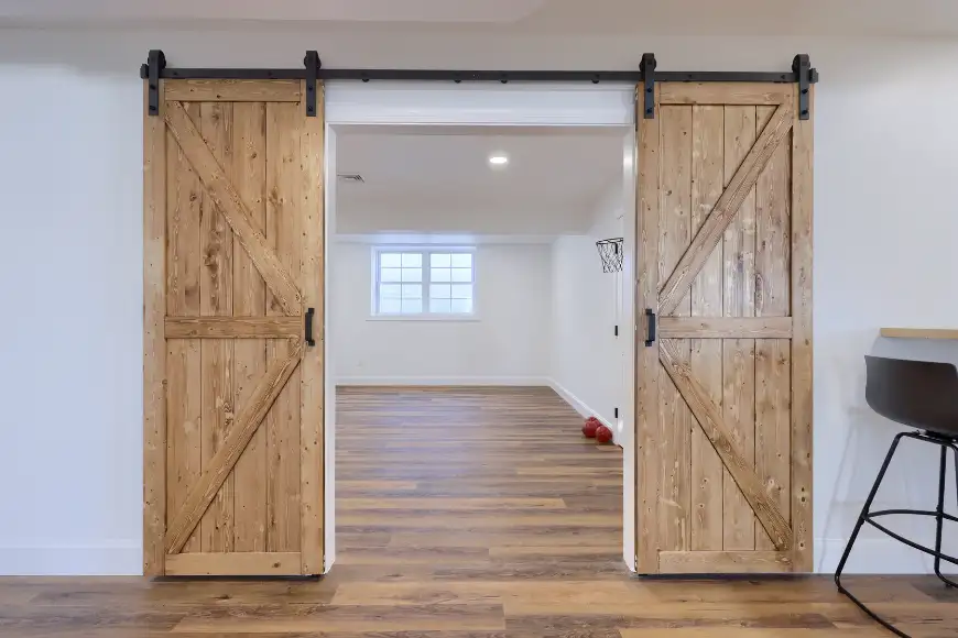 S. King Home Improvements custom basement remodel with sliding barn doors and wood floors in Lancaster County PA