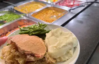 Alt text: Shady Maple Smorgasbord Pennsylvania Dutch buffet plate with pork mashed potatoes and green beans - Lancaster PA