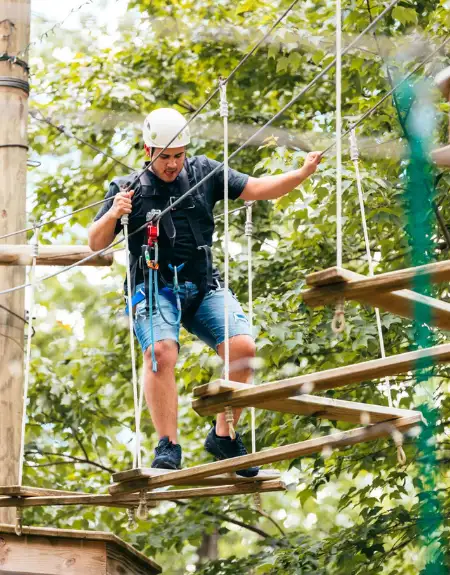 Adult on aerial ropes course and treetop adventure at Refreshing Mountain in Stevens Lancaster County PA