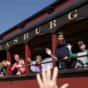 Family waving from the Strasburg Rail Road train in Lancaster County PA