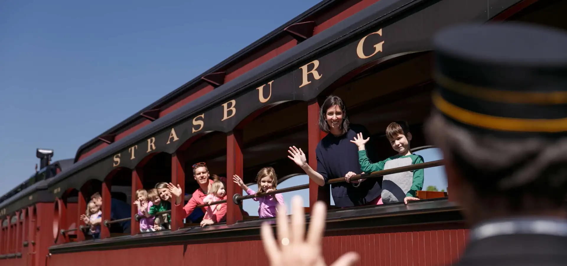 Family waving from the Strasburg Rail Road train in Lancaster County PA