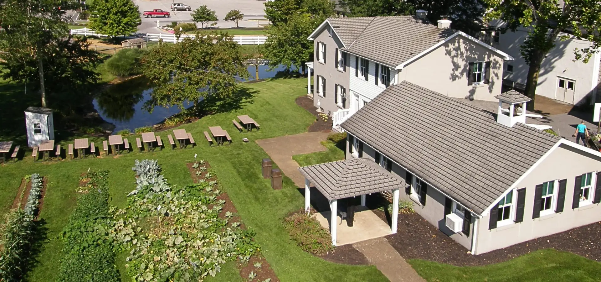 Aerial view of an Amish country homestead with gardens and pond on a guided tour in Lancaster County PA