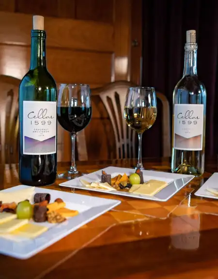 Cellar 1599 wine bottles and tasting glasses with charcuterie at a Lancaster County PA winery
