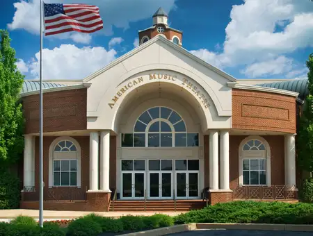 American Music Theatre exterior building facade with American flag in Lancaster PA live entertainment venue