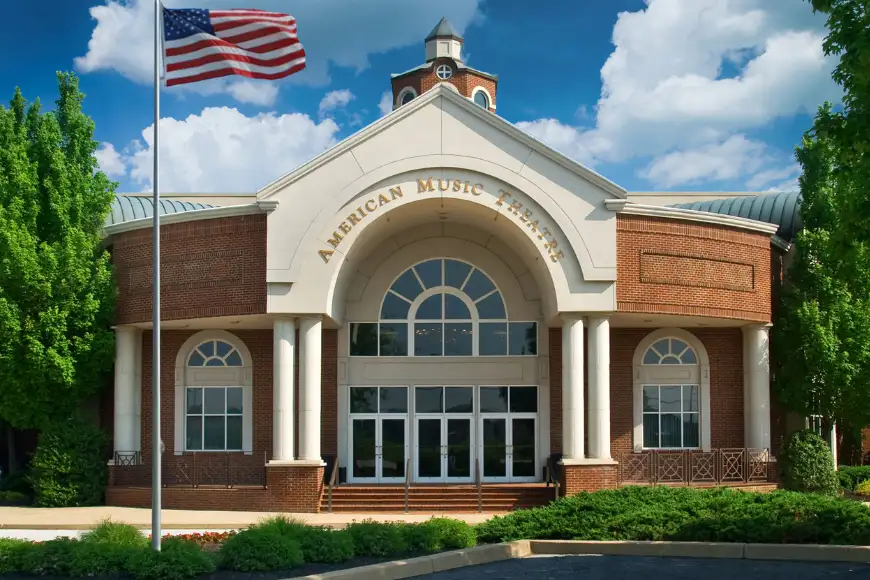 American Music Theatre brick building exterior with American flag and white columns in Lancaster PA