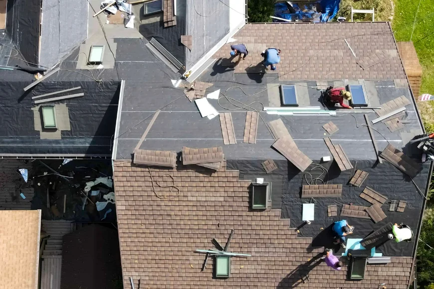 American Remodeling Enterprises roofing crew laying shingles and underlayment on Lancaster PA home aerial view