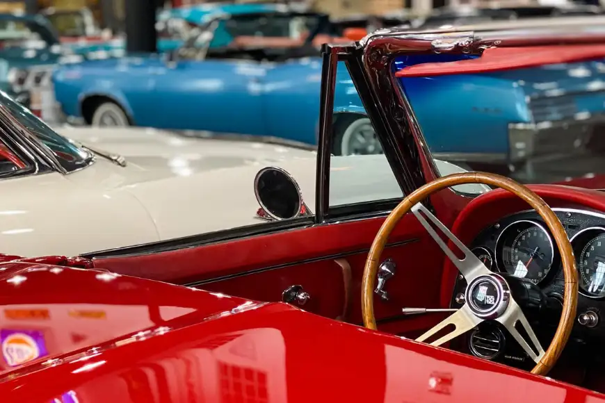 Vintage red convertible interior with wood steering wheel at Barry's Car Barn Antique Car Museum in Lancaster PA