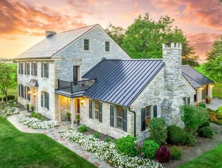 Blue Ridge Builders Amish-built stone home with metal roof and balcony in Lancaster PA