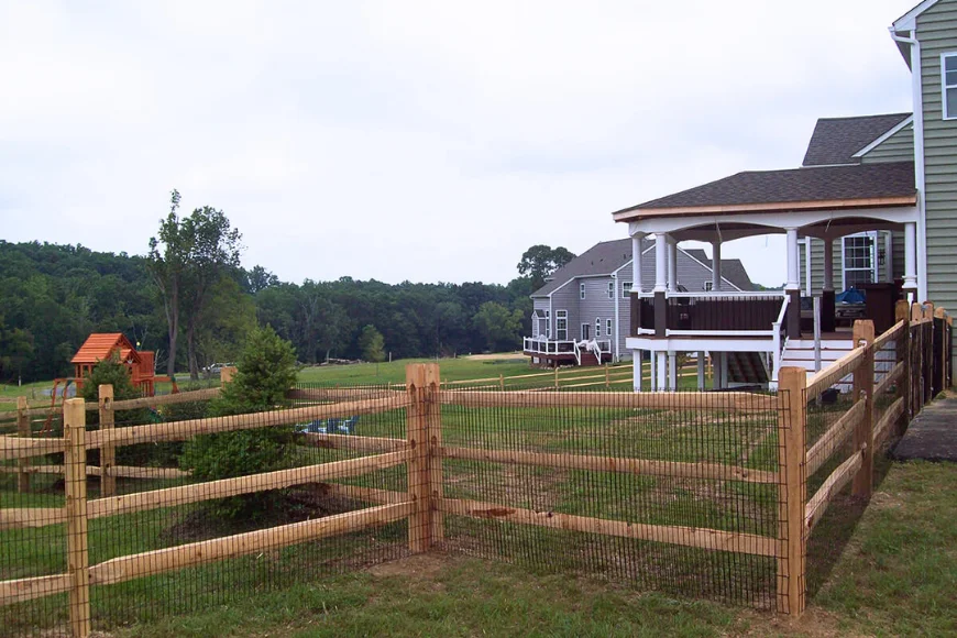 Chester County Fencing split rail wood fence with wire mesh installed in Lancaster PA residential backyard