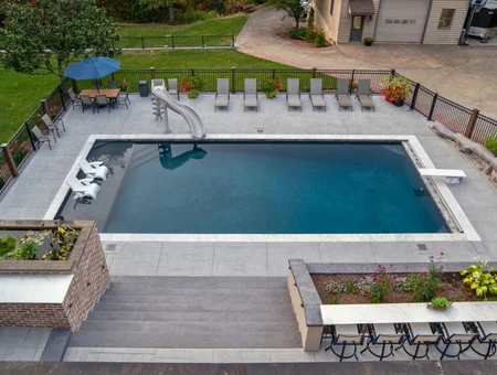 Concrete Authority aerial view of concrete pool deck with lounge chairs and landscaping in Lancaster PA