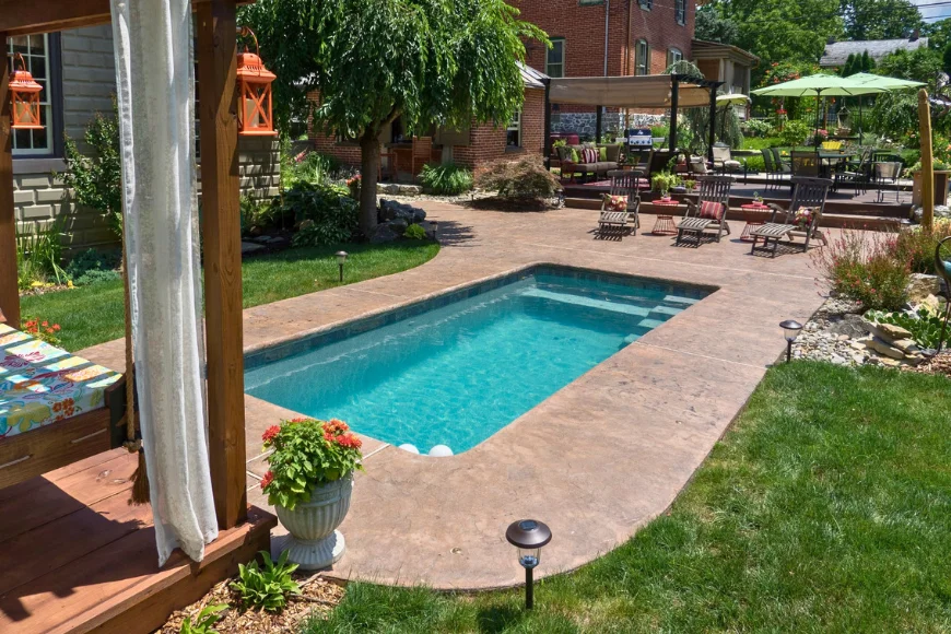 Concrete Authority stamped concrete pool deck with pergola and outdoor seating in Lancaster PA backyard