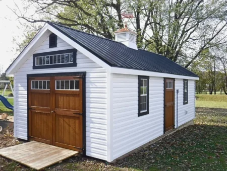 Country Tyme Sheds white vinyl shed with black metal roof wood carriage doors and cupola in Lancaster PA