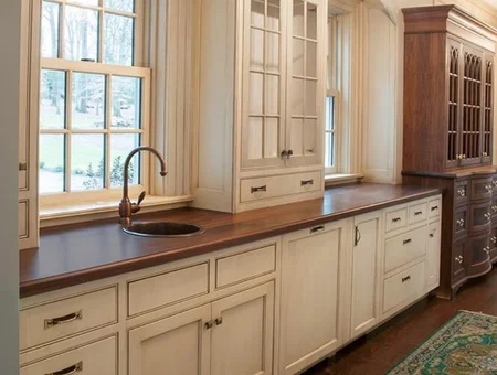 Custom cream kitchen cabinets with wood countertops and undermount sink by Custom Cabinetry Unlimited in Lancaster PA