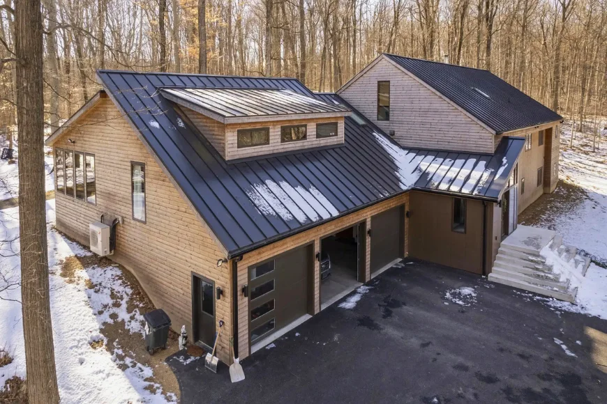 Standing seam metal roof installation on modern wood home in winter by DuraCraft Roofing in Lancaster PA