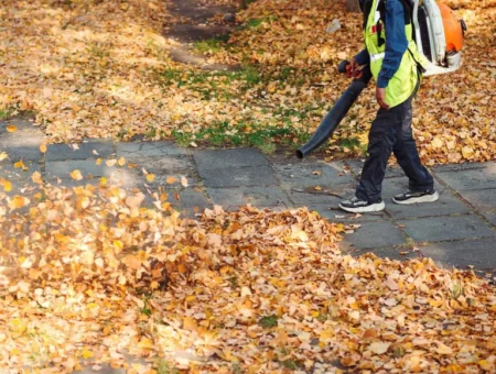 Landscaper using backpack leaf blower for fall leaf removal service by DWD Landscaping in Lancaster PA