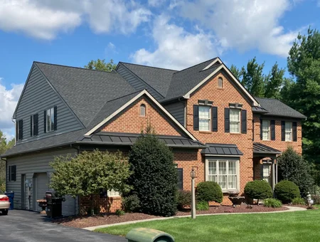 Amish roofing contractor installation on brick colonial home with dark architectural shingles by Echo Valley Roofing in Lancaster PA