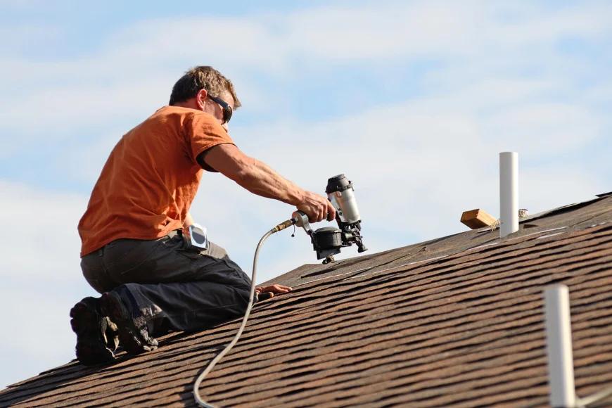 Roofer nailing shingles with pneumatic nail gun during residential roof installation by Echo Valley Roofing in Lancaster PA