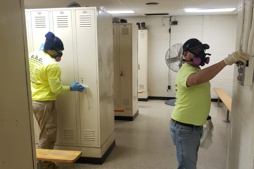 EHC Associates workers with respirators performing mold or hazardous material remediation in locker room in Lancaster PA