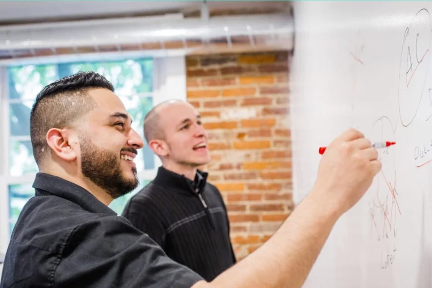 Marketing team brainstorming strategy on whiteboard at E-Impact Marketing for blue collar businesses in Lancaster PA