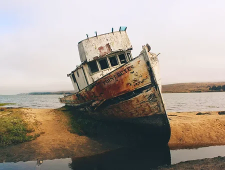 Abandoned shipwrecked boat on shore symbolizing brokenness and restoration through Embracing Brokenness Ministries in Lancaster PA