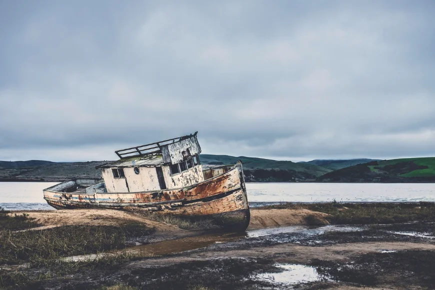 Rusted abandoned boat stranded on shore representing hope and healing through Embracing Brokenness Ministries in Lancaster PA