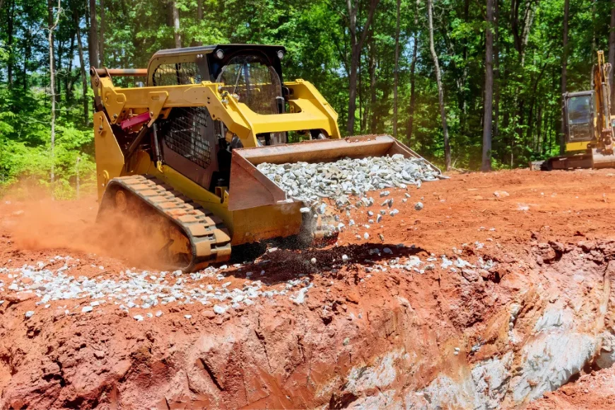 Track loader spreading gravel during site preparation and land clearing by Emerald Power Solutions in Lancaster PA