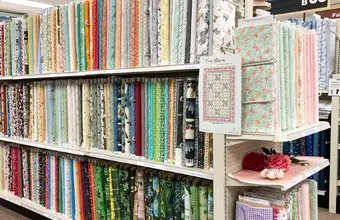 Bolts of quilting fabric and handmade quilts at Goods Store in Lancaster County PA