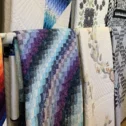 Amish handmade quilts and fabric bolts displayed at Old Country Store Lancaster County PA