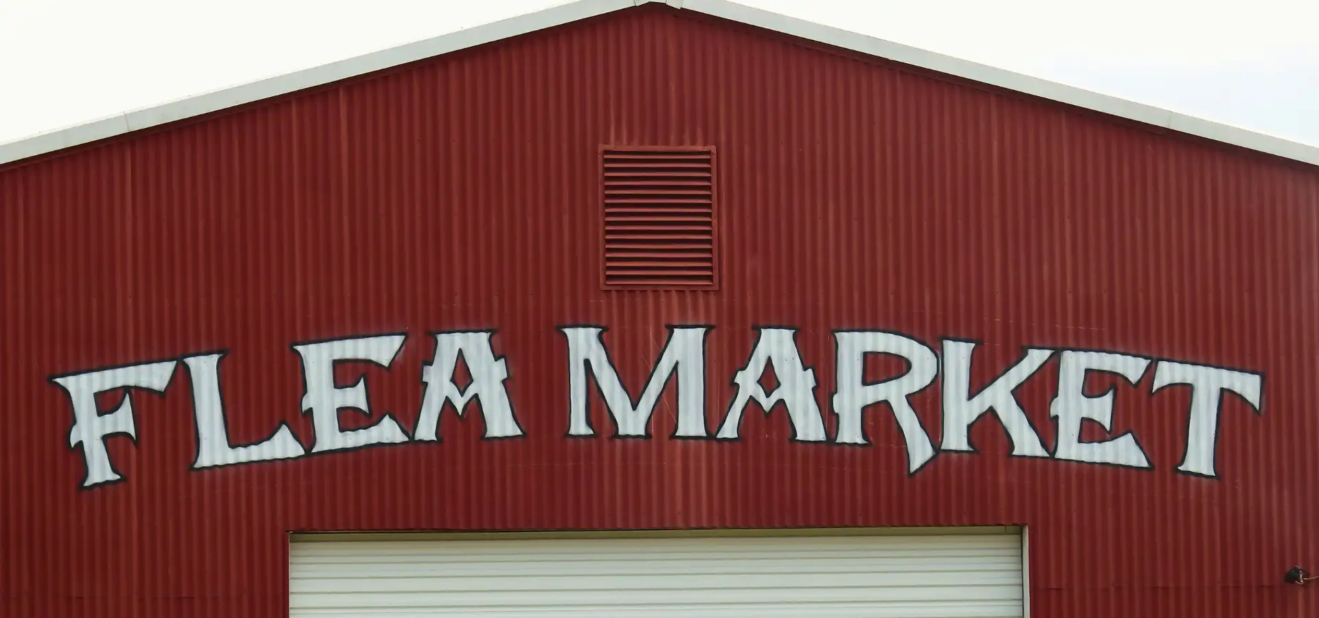 Red barn flea market sign at Lancaster County PA outdoor flea market