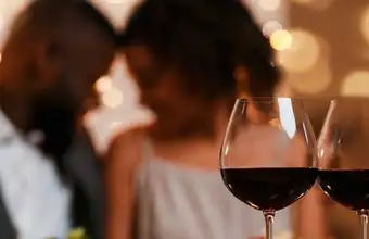 Couple sharing wine glasses on a romantic getaway package at Inn and Spa at Intercourse Village in Lancaster PA