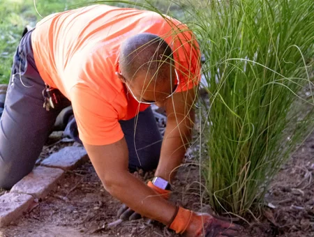 Heemers Lawn Care technician trimming ornamental grass during landscaping service in Lancaster PA