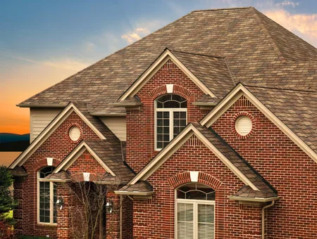 Joyland Roofing architectural shingle roof installation on brick home at sunset in Lancaster PA