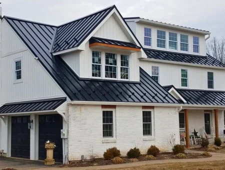 Lititz Roofing black metal roof installation on white brick farmhouse style home in Lancaster PA