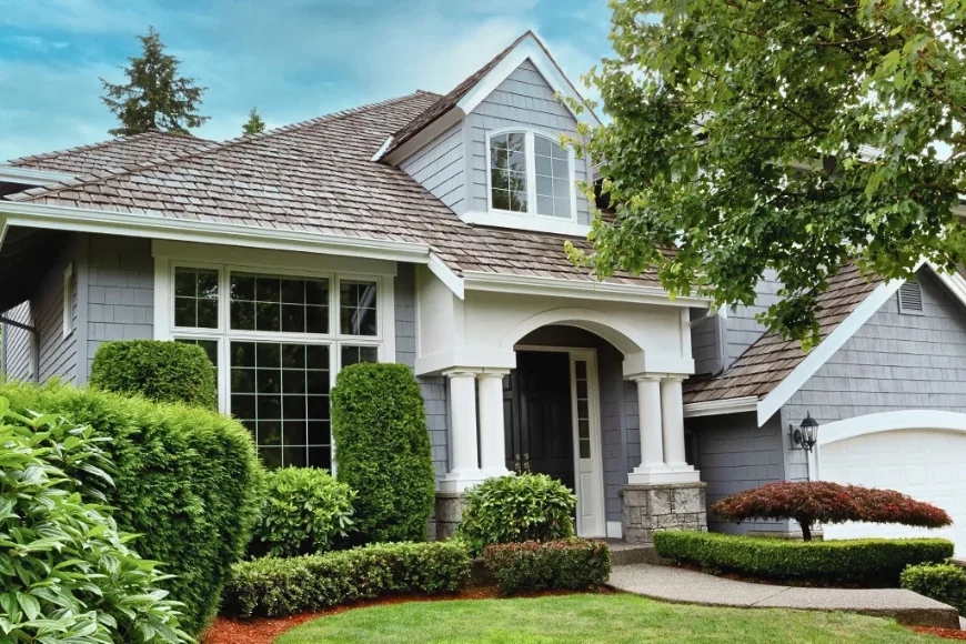 Lititz Roofing cedar shake roof on gray shingle home with arched entry and landscaping in Lancaster PA