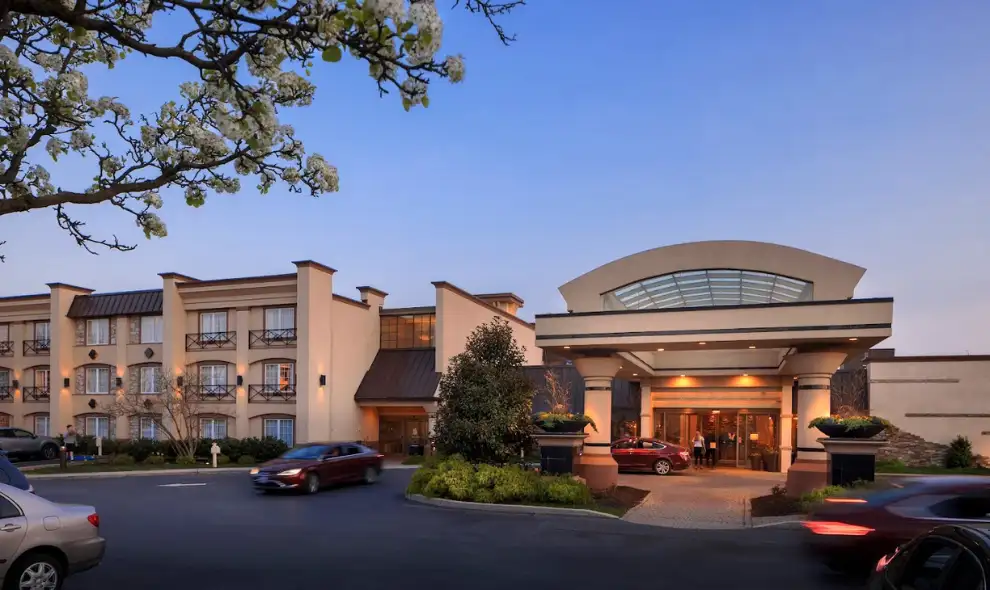 Eden Resort and Suites hotel entrance at dusk with spring blossoms in Lancaster PA