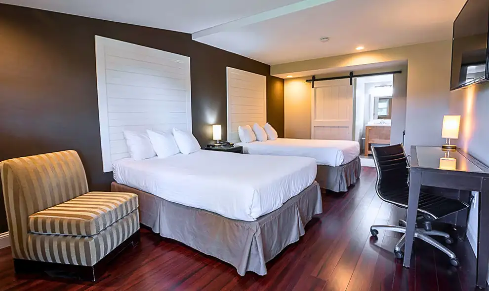 Modern hotel room with double queen beds and barn door at Hershey Farm Resort in Lancaster PA