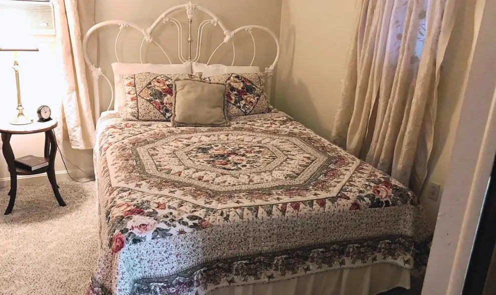 Vacation rental bedroom with floral quilt at Leaman's Country Lodge in Lancaster PA