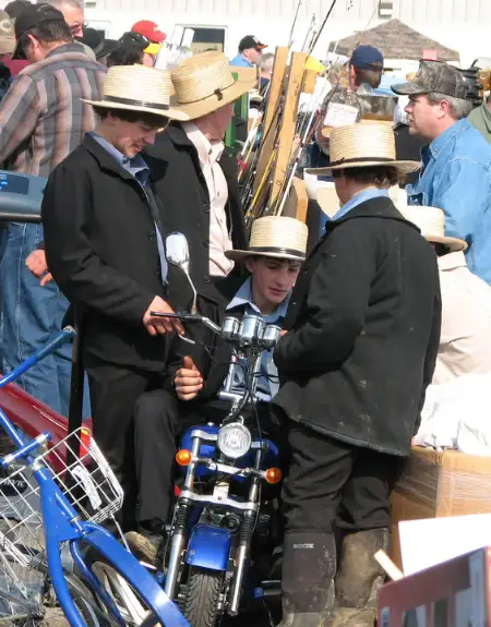 Amish men inspecting motorcycles for sale at Lancaster County PA mud sale fundraiser