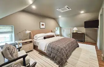 Cozy neutral toned bedroom with hardwood floors at Mill Creek Manor pet friendly lodging in Lancaster PA