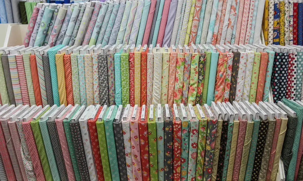 Lancaster Home Fabrics store wall of colorful fabric bolts for quilting and sewing - Lancaster PA fabric shop